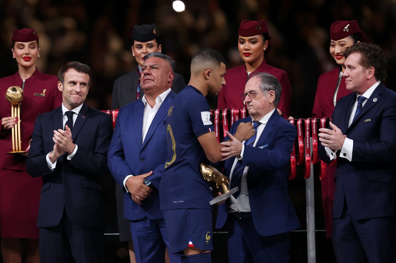 French Football Federation President Noel Le Graet congratulates Kylian Mbappe during the awards ceremony after the FIFA World Cup Qatar 2022 final match between Argentina and France at Lusail Stadium, Lusail City, Qatar, Dec. 18, 2022. (Getty Images Photo)