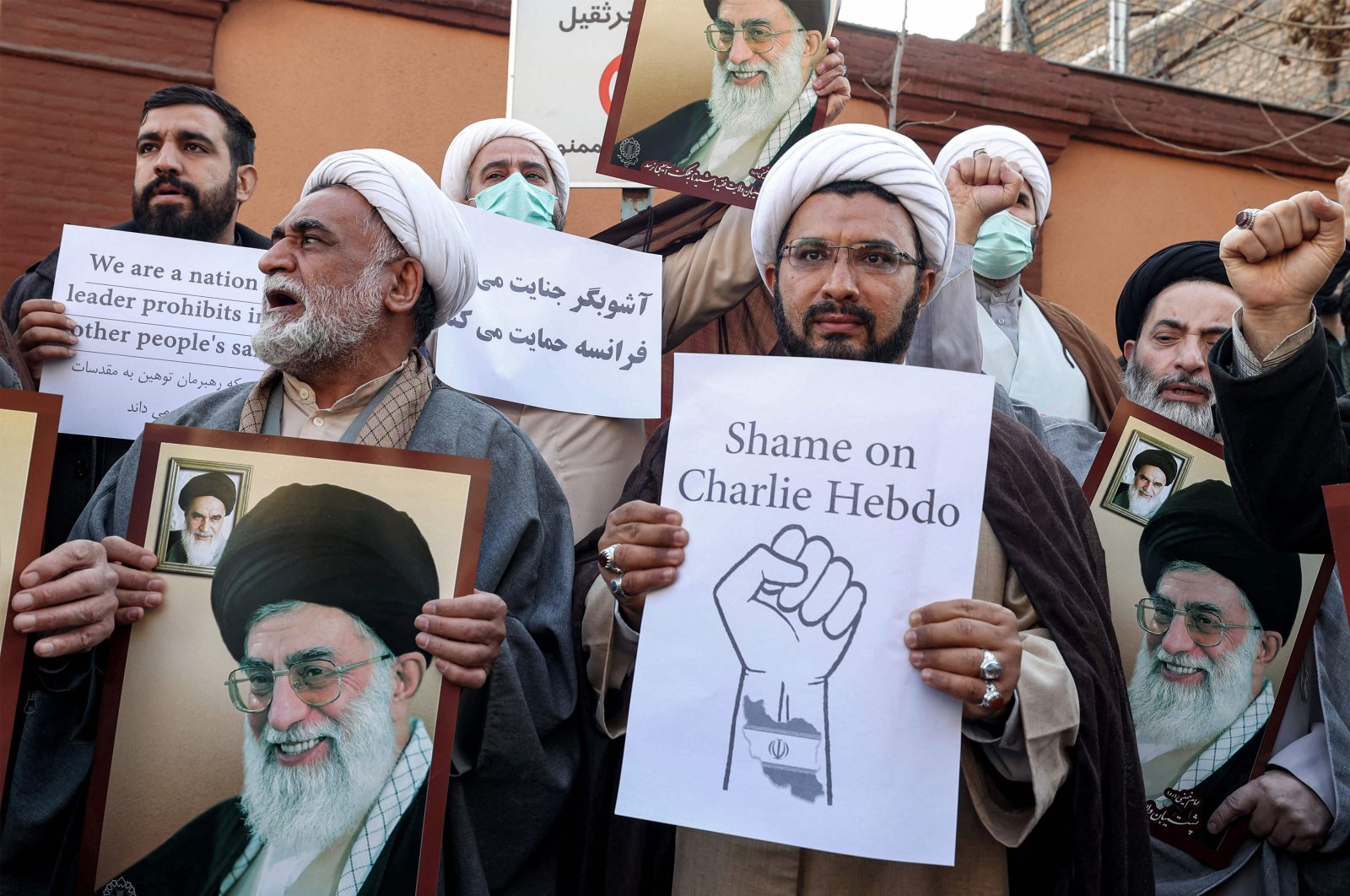 Demonstrators gather with images of Iran&#039;s supreme leader Ayatollah Ali Khamenei during a protest against defamatory cartoons depicting him published by French satirical weekly Charlie Hebdo, outside the French embassy in Tehran, Iran, Jan. 8, 2023. (AFP Photo)