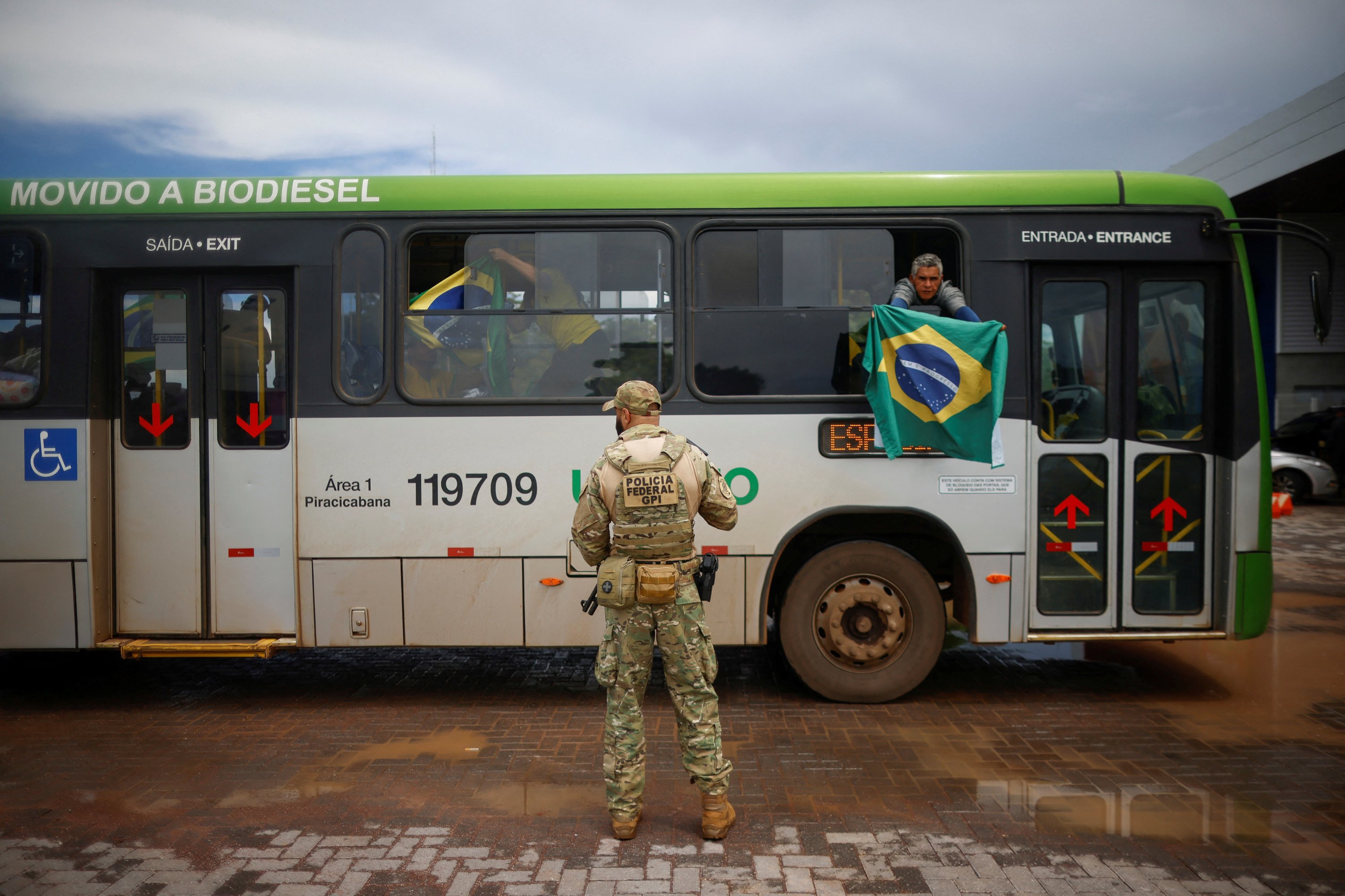 Brezilya'nın eski Devlet Başkanı Jair Bolsonaro'nun bir destekçisi, 9 Ocak 2023, Brasilia, Brezilya'daki Ulusal Federal Polis Akademisine vardıklarında elinde bir bayrak tutuyor. (Reuters Fotoğrafı)