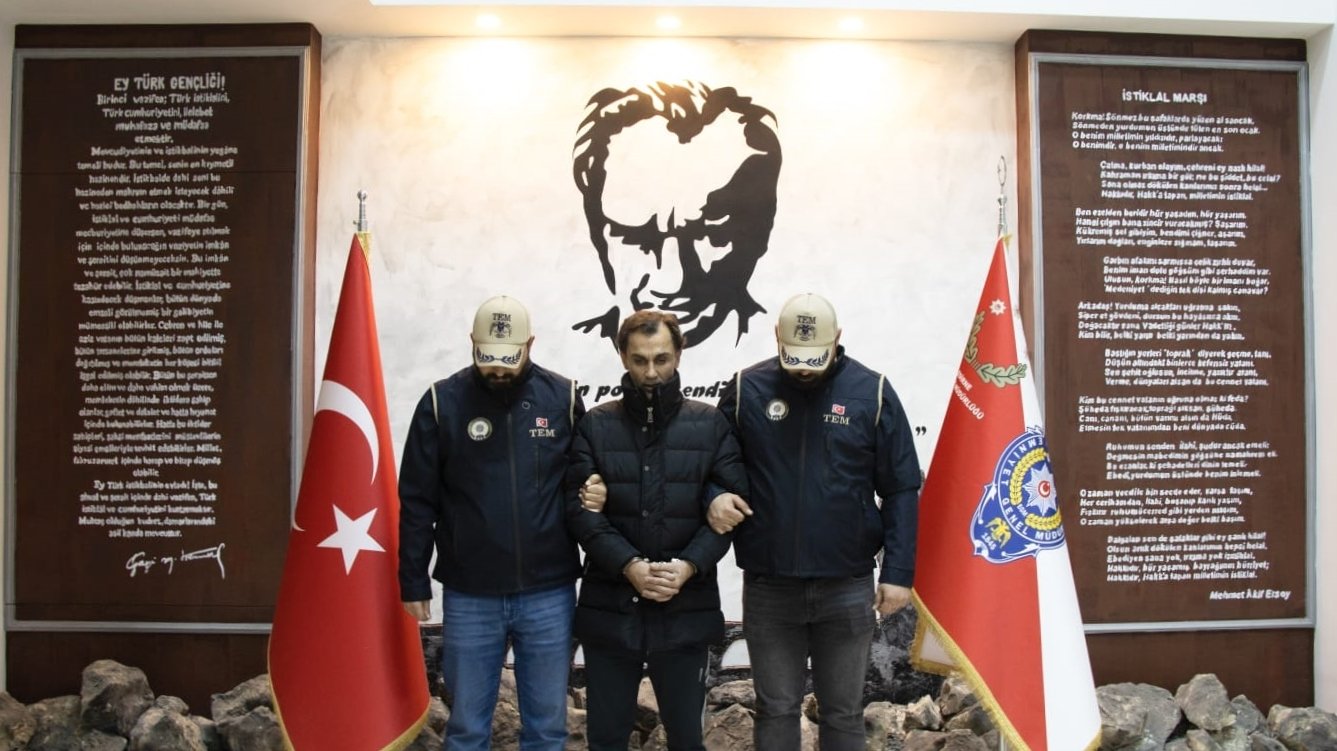 Suspect Hazni Gölge, who helped fugitive suspect Bilal Hassan escape the country, is pictured with security forces at an undisclosed location in this photo released on Jan. 10, 2022. (AA Photo)