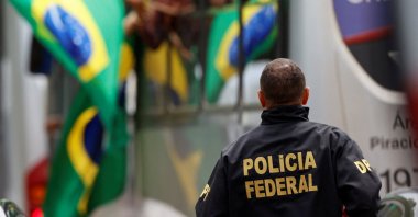 A member of the Federal Police looks on as supporters of Brazil's former President Jair Bolsonaro arrive at the National Academy of the Federal Police, Brasilia, Brazil, Jan. 9, 2023. (Reuters Photo)