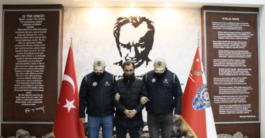 Suspect Hazni Gölge, who helped fugitive suspect Bilal Hassan escape the country, is pictured with security forces at an undisclosed location in this photo released on Jan. 10, 2022. (AA Photo)