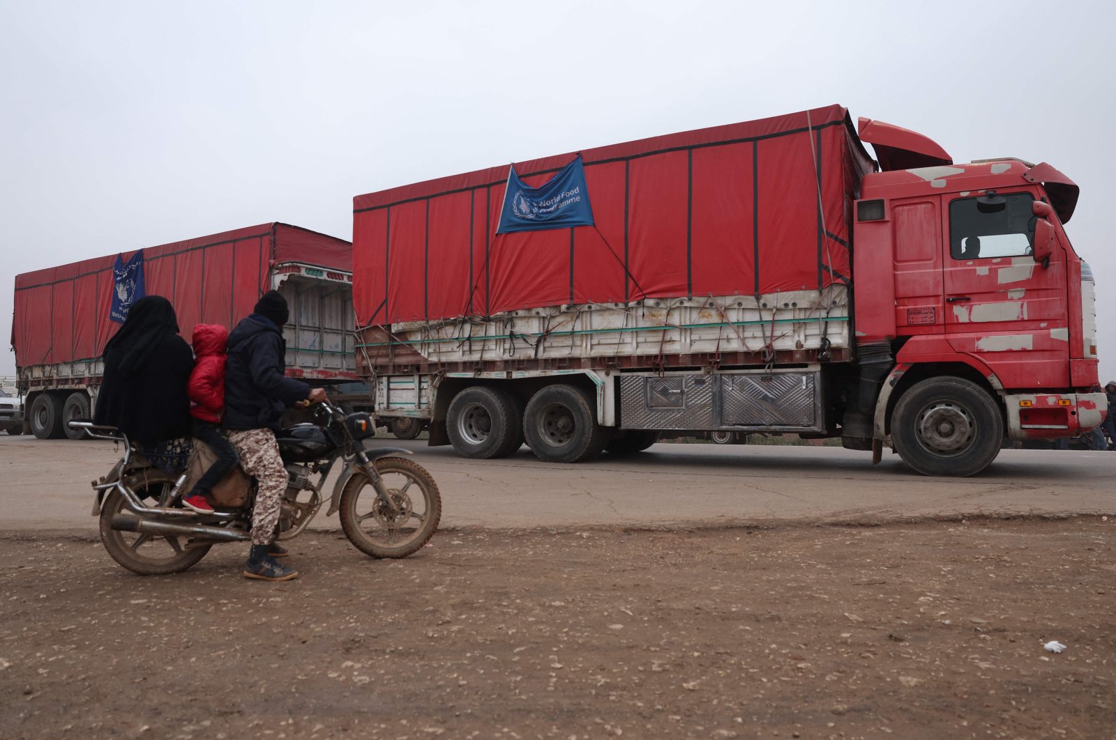 Trucks carrying aid packages from the World Food Program (WFP) drive through the opposition-held northwestern city of Idlib, Syria, Jan. 8, 2023. (AFP Photo)