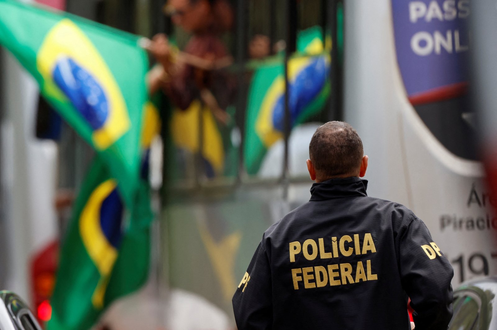A member of the Federal Police looks on as supporters of Brazil's former President Jair Bolsonaro arrive at the National Academy of the Federal Police, Brasilia, Brazil, Jan. 9, 2023. (Reuters Photo)