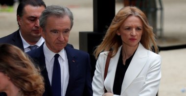 Bernard Arnault (L), CEO of LVMH Moet Hennessy Louis Vuitton SE, and Delphine Arnault (R), Executive Vice President of Louis Vuitton, leave after the Spring/Summer 2020 collection show for fashion house Louis Vuitton during Men&#039;s Fashion Week in Paris, France, June 20, 2019. (Reuters Photo)