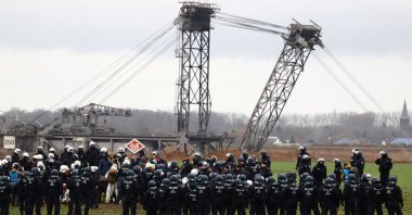 Police keep guard as activists stage a sit-in protest against the expansion of the Garzweiler open-cast lignite mine of Germany's utility RWE, in Luetzerath, Germany, Jan.11, 2023. (Reuters Photo)