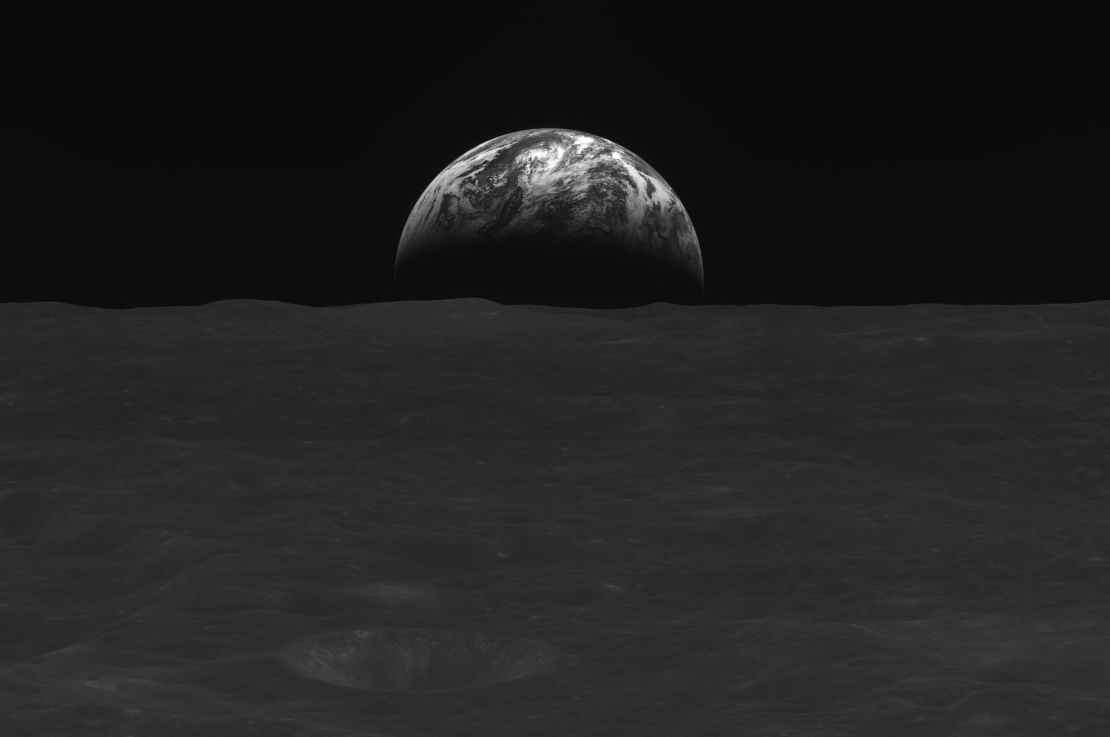 A black-and-white image of the lunar surface and Earth taken by South Korean lunar orbiter Danuri after reaching the moon&#039;s orbit, Dec. 31, 2022. (AFP Photo)