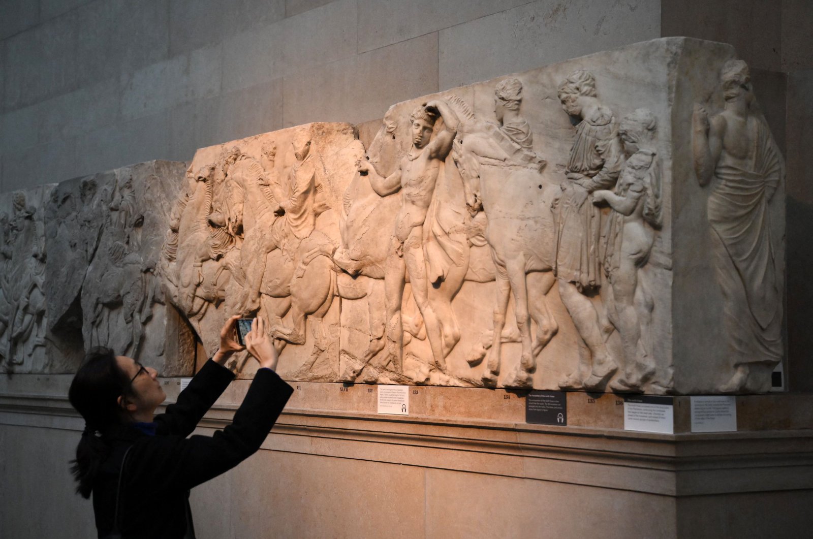 Visitors view the Parthenon Marbles, also known as the Elgin Marbles, at the British Museum in London on Jan. 9, 2023. (AFP Photo)