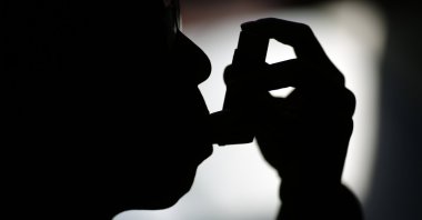 A patient, takes medicine for his bronchial trouble at his house in Beijing, China, Nov. 2, 2014. (Reuters Photo)