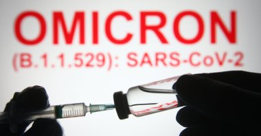 COVID-19 variant Omicron a medical syringe and a vial are seen. (Shutterstock Photo)