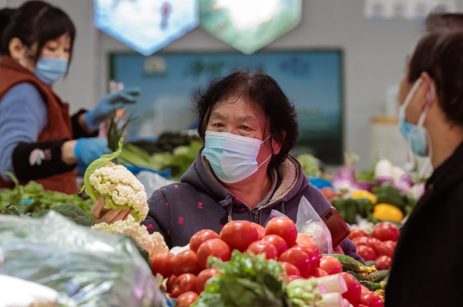 A woman buys vegetables from a wet market in Shanghai, China, Jan. 11, 2023. (EPA Photo)
