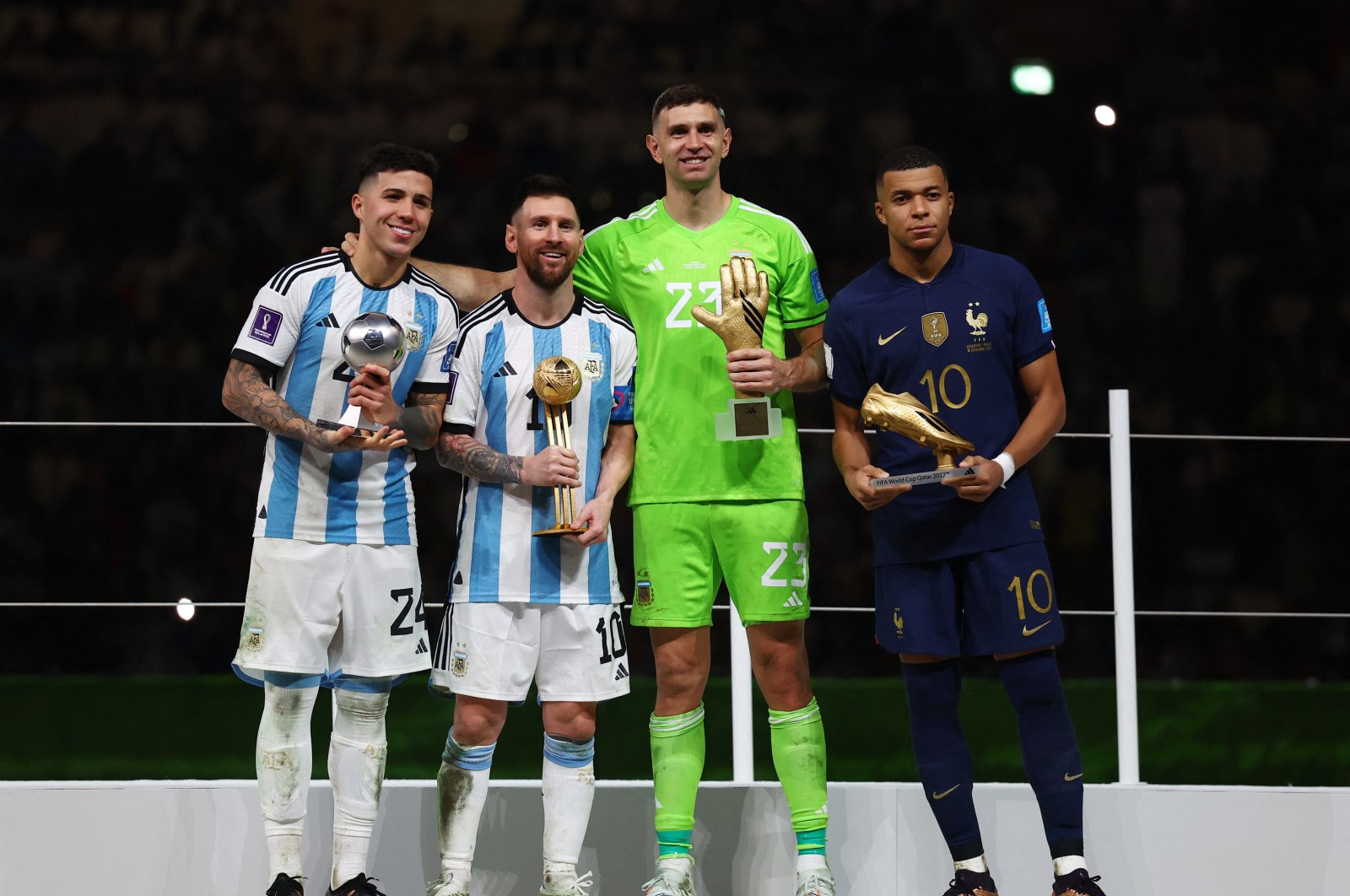 From left, Argentina&#039;s Enzo Fernandez, Argentina&#039;s Lionel Messi, Argentina&#039;s Emiliano Martinez and France&#039;s Kylian Mbappe pose after being awarded the Best Young Player, Golden Ball, Golden Glove and Golden Boot, respectively, after the FIFA World Cup Qatar 2022 final match between Argentina and France at Lusail Stadium, Lusail, Qatar, December 18, 2022. (Reuters Photo)