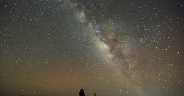 The Milky Way is seen in the night sky around telescopes and camps of people over rocks in the White Desert north of the Farafra Oasis, southwest of Cairo, Egypt, May 16, 2015. (Reuters Photo)
