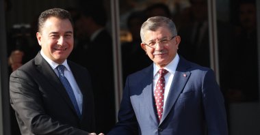 Future Party (GP) Chair Ahmet Davutoglu (R) and Democracy and Progress Party (DEVA) Chair Ali Babacan shake hands before a meeting in Ankara, Türkiye, Jan. 5, 2023. (AFP Photo)