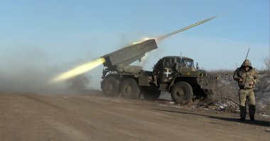 This screengrab shows a member of Ukraine's military looking away as a BM-21'Grad' rocket launcher fires on the outskirts of Soledar, eastern Ukraine, Jan. 11, 2023. (AFP Photo)