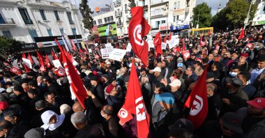 Tunisian demonstrators wave the national flag during a protest in central Tunis against their president on Jan. 14, 2023. (AFP Photo)