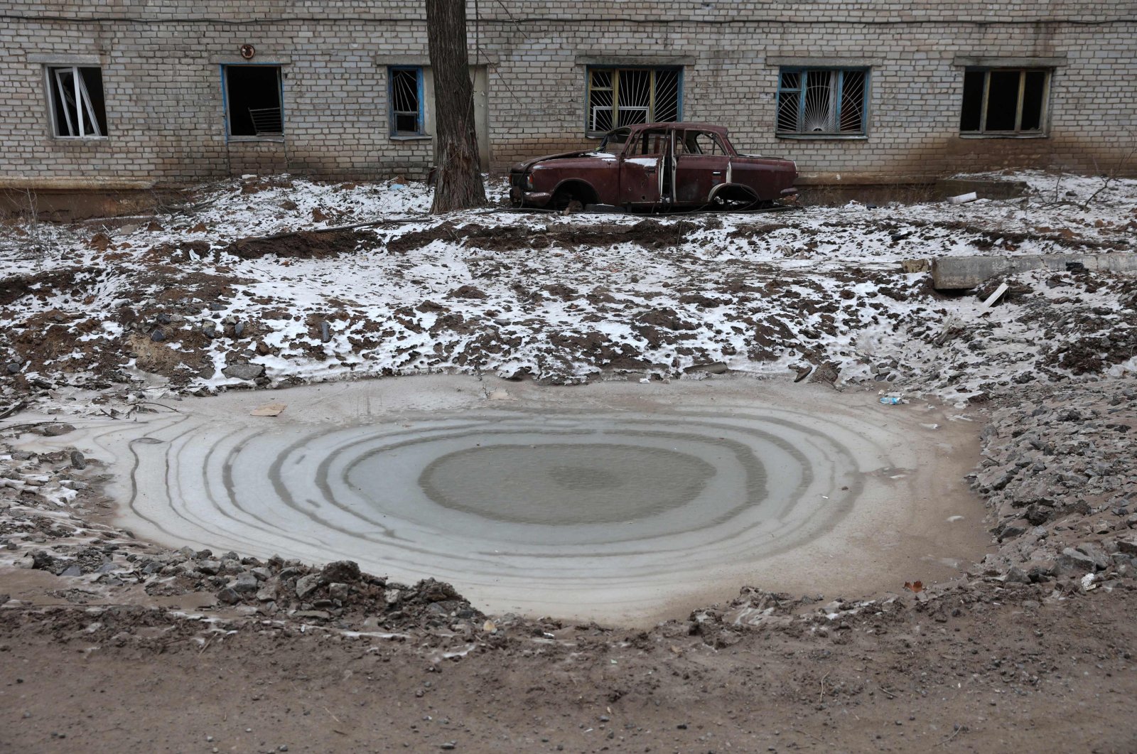 Ice covers a bomb crater in the town of Siversk, Donetsk region, as the Russia-Ukraine war enters its 324th day, Jan. 13, 2023. (AFP Photo)