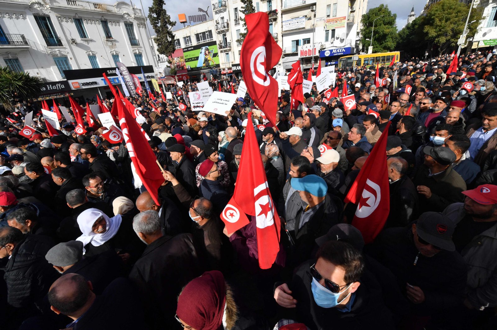Tunisian demonstrators wave the national flag during a protest in central Tunis against their president on Jan. 14, 2023. (AFP Photo)