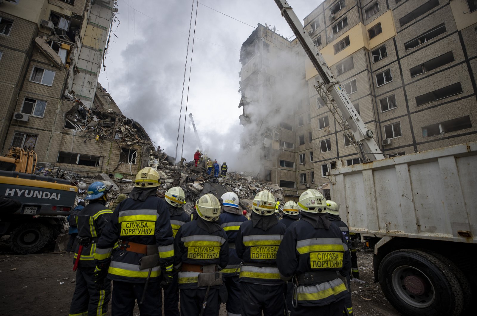 Rescuers at the apartment block heavily damaged by a Russian missile strike, Dnipro, Ukraine, Jan. 15, 2023. (Reuters Photo)