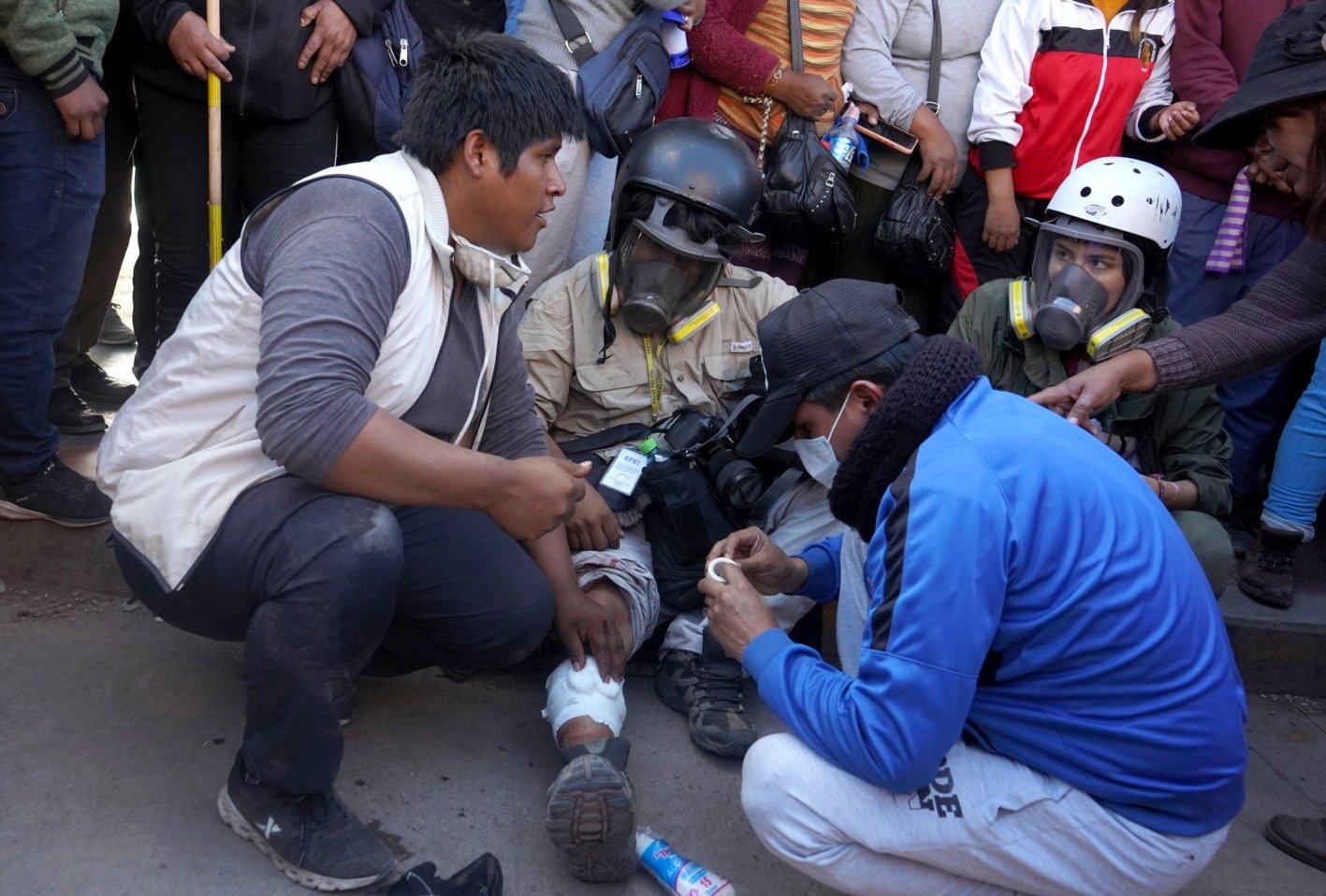 Photojournalist Aldair Mejia receives aid after being injured by a projectile during confrontations between protesters and police, in Juliaca, Peru, 7 Jan. 2023. (EPA Photo)