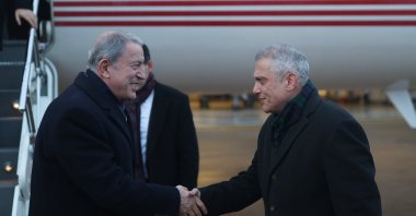 Defense Minister Hulusi Akar (L) is greeted by Türkiye's Ambassador to the U.K. Ümit Yalçın (R) in London, U.K., Jan. 15, 2023. (AA Photo)