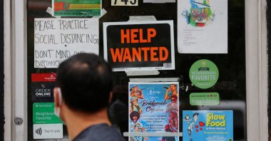 A pedestrian passes a &quot;Help Wanted&quot; sign on the door of a hardware store in Cambridge, Massachusetts, U.S., July 8, 2022. (Reuters Photo)
