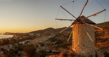 A windmill overlooking Foça, in Izmir, Türkiye. (Shutterstock Photo)
