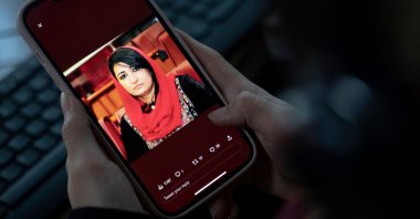 A woman looks at a picture of former Afghan lawmaker Mursal Nabizada on her mobile phone, who was shot dead by gunmen last night at her house in Kabul, Afghanistan, Jan. 15, 2023. (AFP Photo)