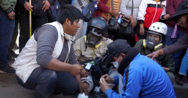 Photojournalist Aldair Mejia receives aid after being injured by a projectile during confrontations between protesters and police, in Juliaca, Peru, 7 Jan. 2023. (EPA Photo)