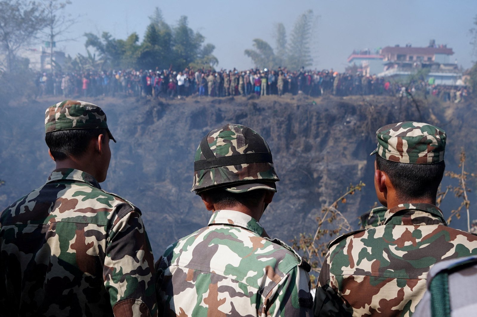 Members of the Nepali Army look toward the crash site of an aircraft, Pokhara, Nepal, Jan. 15, 2023. (Reuters Photo)