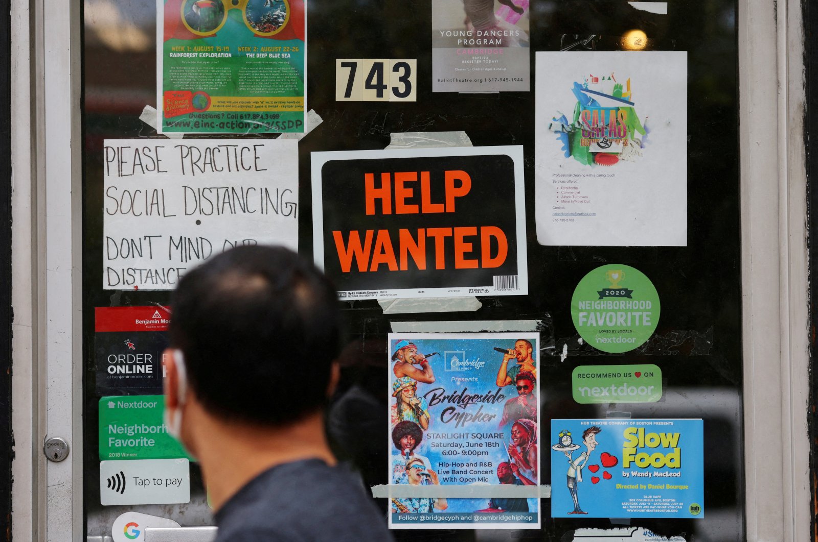 A pedestrian passes a &quot;Help Wanted&quot; sign on the door of a hardware store in Cambridge, Massachusetts, U.S., July 8, 2022. (Reuters Photo)