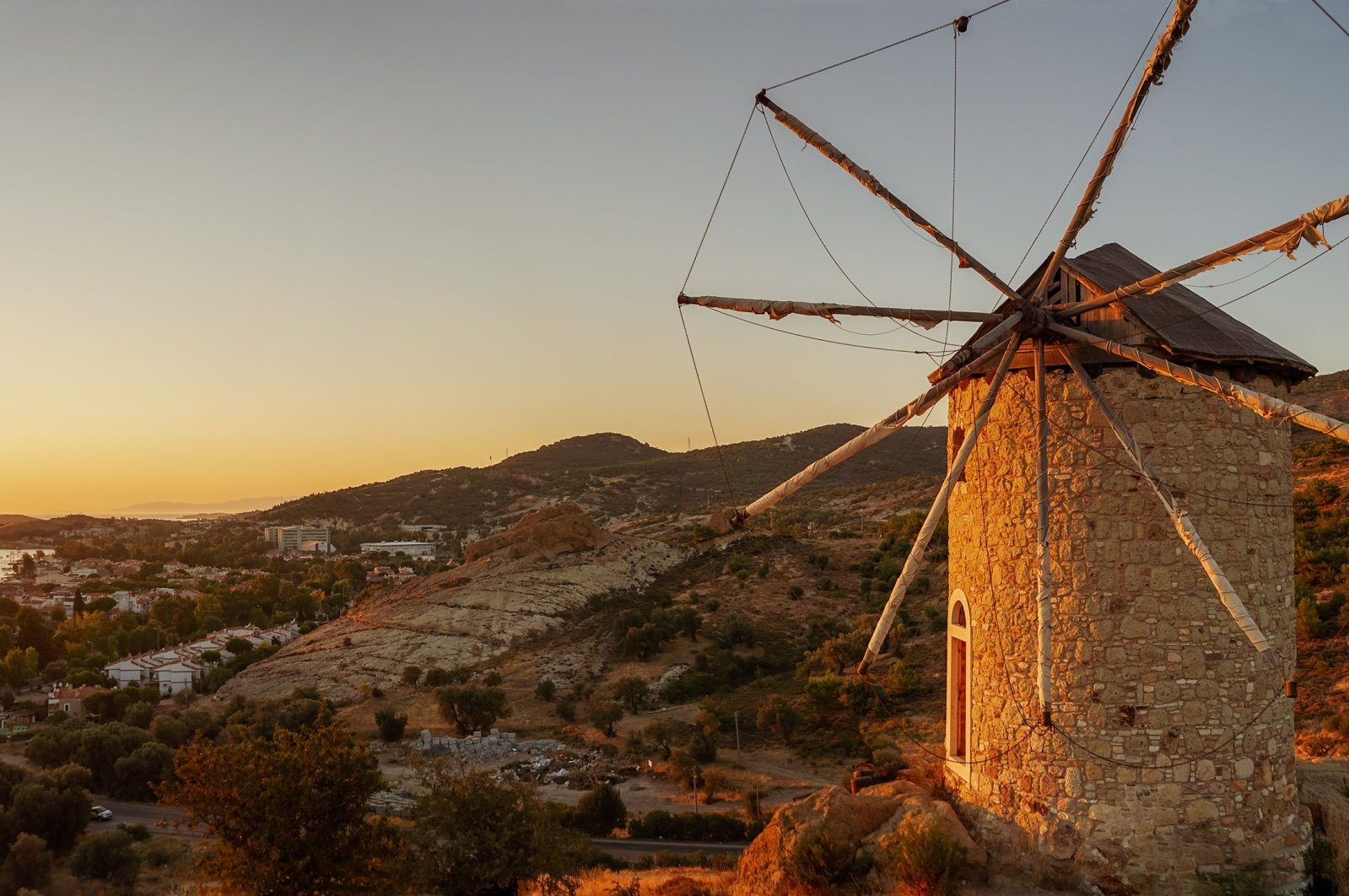 A windmill overlooking Foça, in Izmir, Türkiye. (Shutterstock Photo)