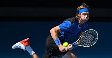 Russia&#039;s Andrey Rublev hits a return against Austria&#039;s Dominic Thiem during their men&#039;s singles match on Day Two of the Australian Open tennis tournament, Melbourne, Australia, Jan. 17, 2023. (AFP Photo)