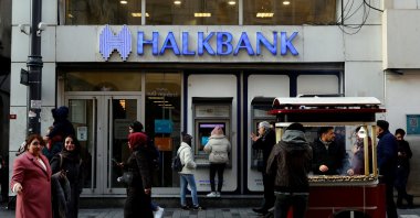 People walk past by a branch of Halkbank in central Istanbul, Türkiye, Jan. 22, 2020. (Reuters File Photo)