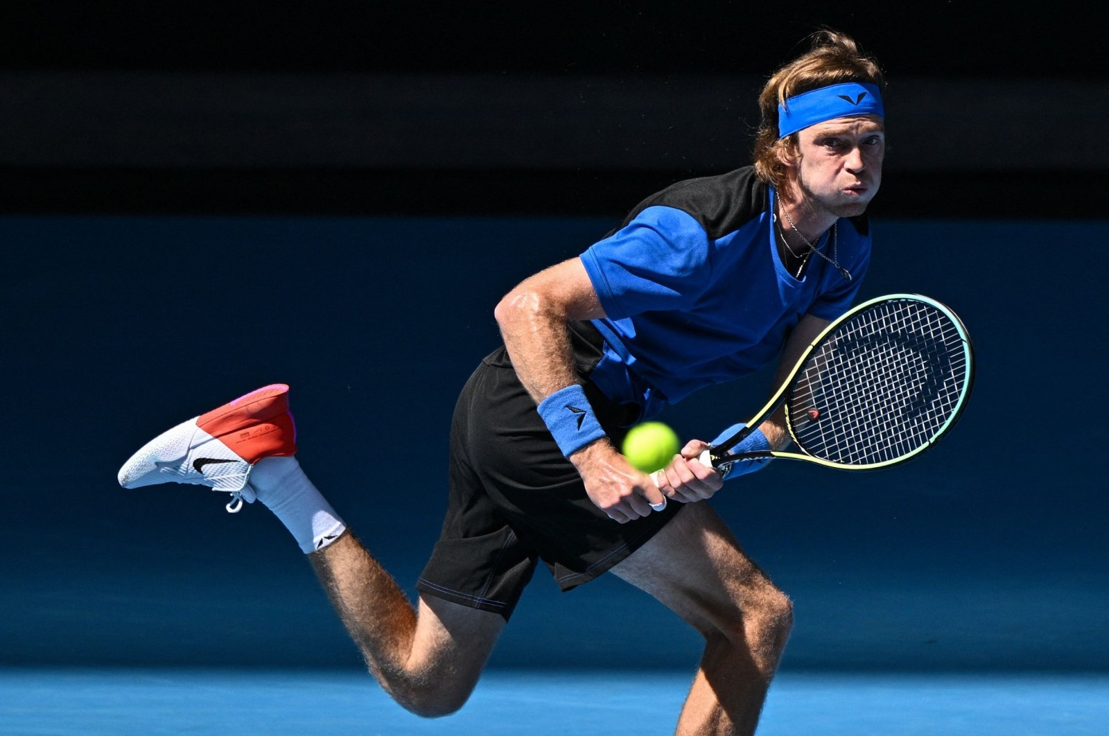 Russia&#039;s Andrey Rublev hits a return against Austria&#039;s Dominic Thiem during their men&#039;s singles match on Day Two of the Australian Open tennis tournament, Melbourne, Australia, Jan. 17, 2023. (AFP Photo)