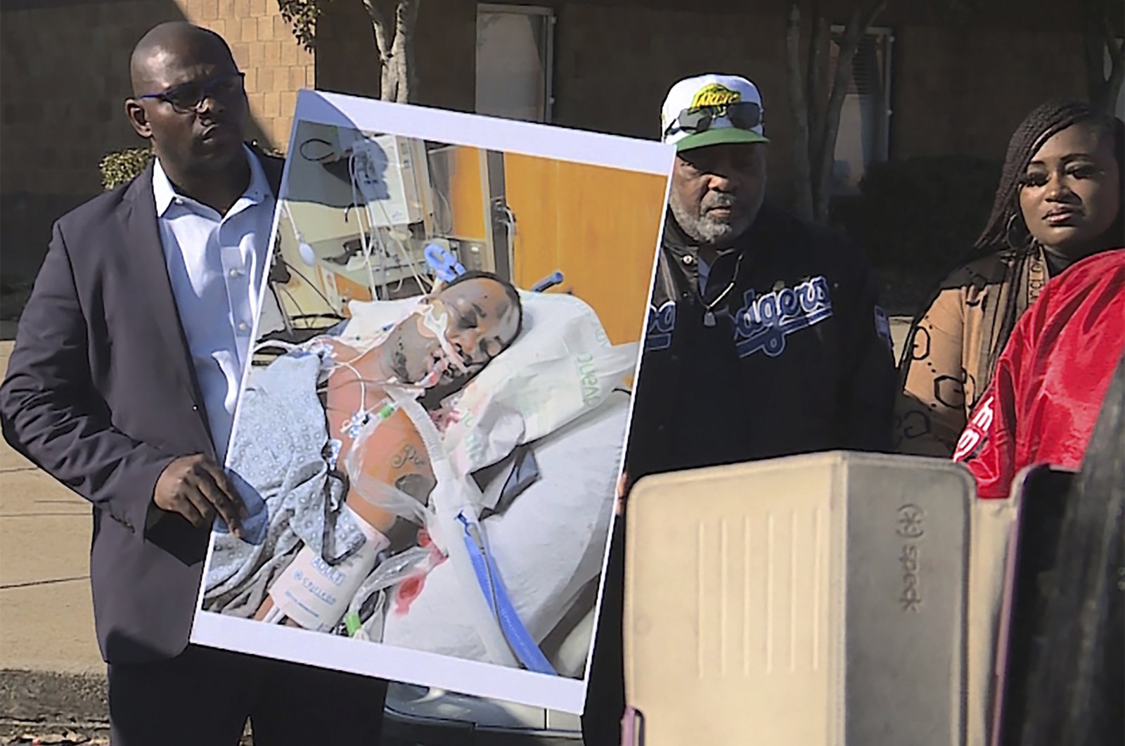 Tyre Nichols&#039; stepfather Rodney Wells (C) stands next to a photo of Nichols in the hospital after his arrest, during a protest in Memphis, Tennesse, U.S., Jan. 14, 2023. (AP Photo)