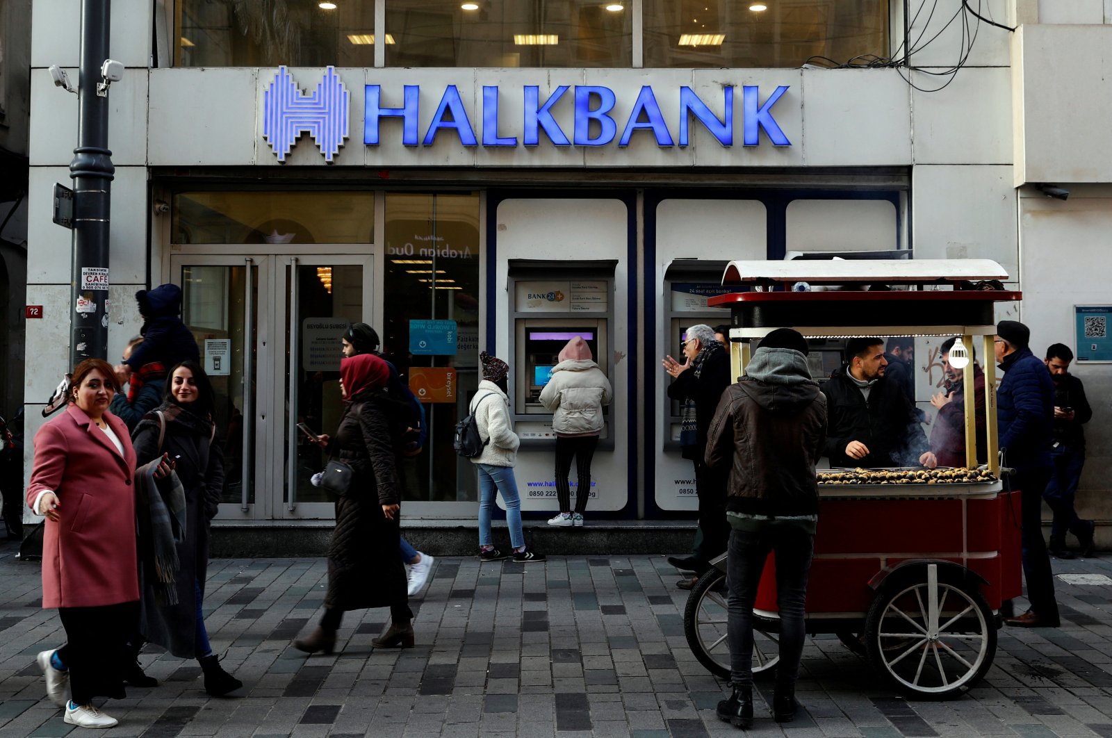 People walk past by a branch of Halkbank in central Istanbul, Türkiye, Jan. 22, 2020. (Reuters File Photo)