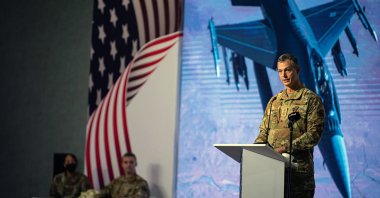 This image provided by the U.S. Air Force shows U.S. Air Force Lt. Gen. Alexus G. Grynkewich, incoming Ninth Air Force (Air Forces Central) commander, delivering a commemorative speech during a change of command ceremony at al-Udeid Air Base, Qatar, July 21, 2022. (AP Photo)