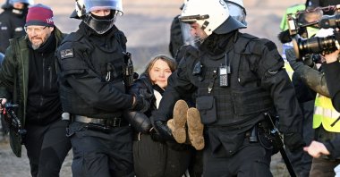 Police officers carry Swedish climate activist Greta Thunberg away from the edge of the Garzweiler II opencast lignite mine during a protest, Luetzerath, Germany, Jan. 17, 2023. (AP Photo)