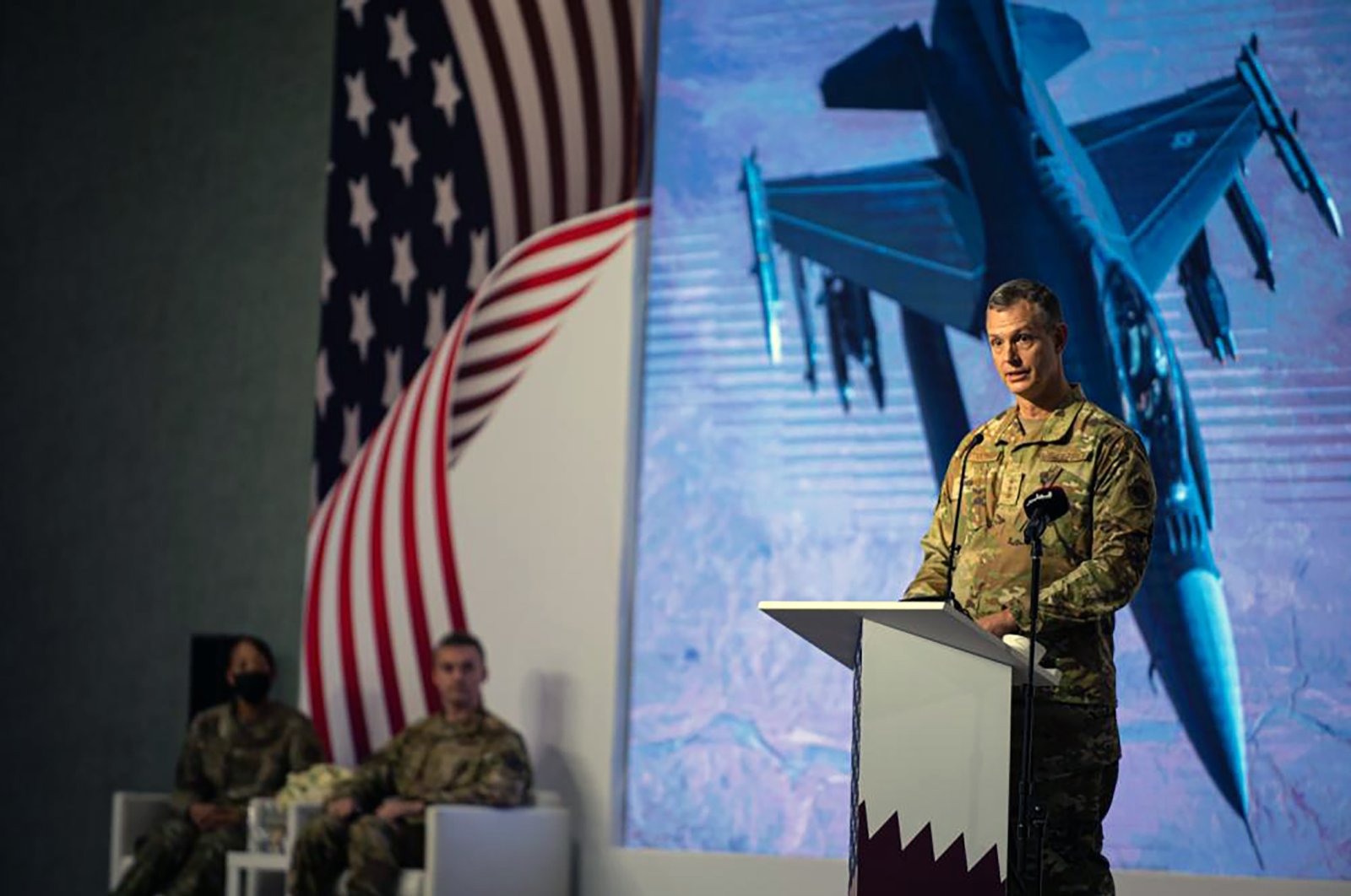 This image provided by the U.S. Air Force shows U.S. Air Force Lt. Gen. Alexus G. Grynkewich, incoming Ninth Air Force (Air Forces Central) commander, delivering a commemorative speech during a change of command ceremony at al-Udeid Air Base, Qatar, July 21, 2022. (AP Photo)