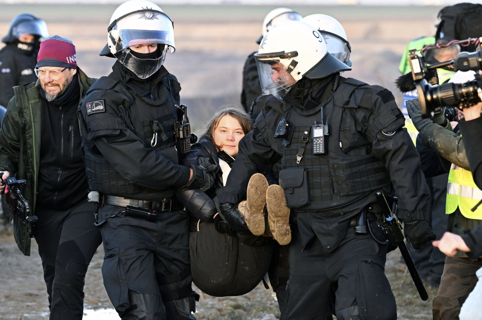Police officers carry Swedish climate activist Greta Thunberg away from the edge of the Garzweiler II opencast lignite mine during a protest, Luetzerath, Germany, Jan. 17, 2023. (AP Photo)