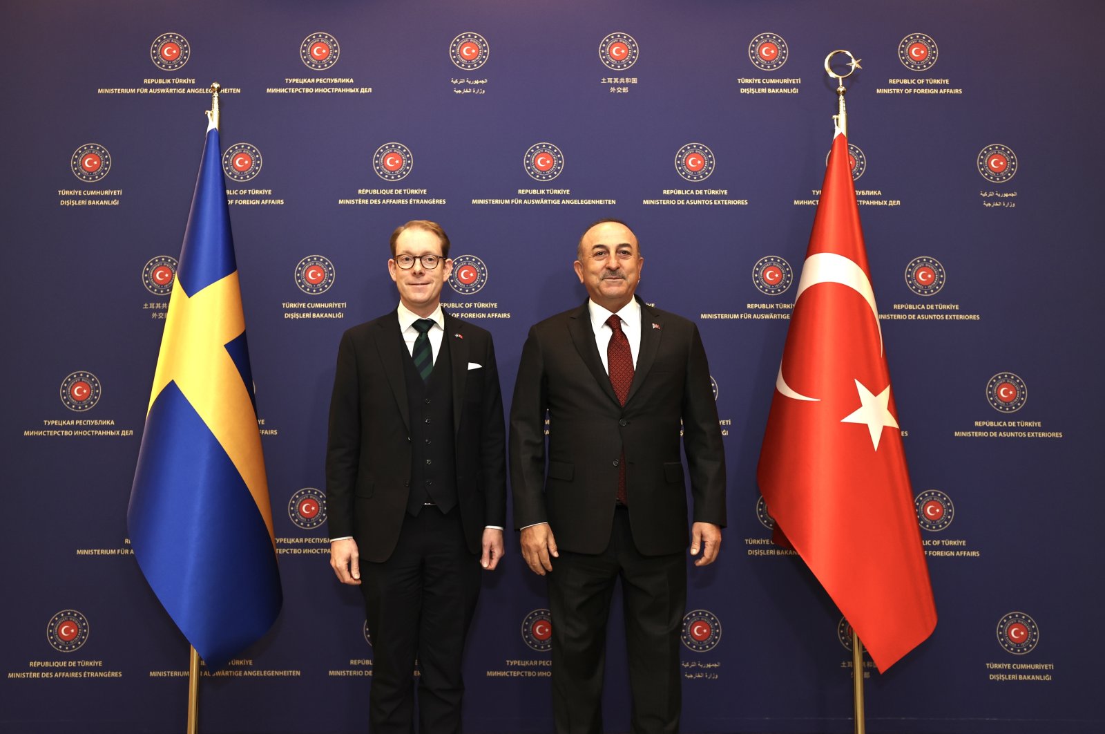 Foreign Minister Mevlüt Çavuşoğlu (R) and his Swedish counterpart Tobias Billström (L) pose between the flags of their countries following a meeting in Ankara, Türkiye. (AA Photo)