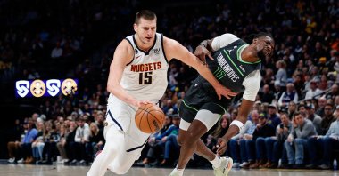 Minnesota Timberwolves center Naz Reid (R) falls to the court after a play with Denver Nuggets center Nikola Jokic (L) in the first quarter at Ball Arena, Denver, US., Jan 18, 2023. (Reuters Photo)