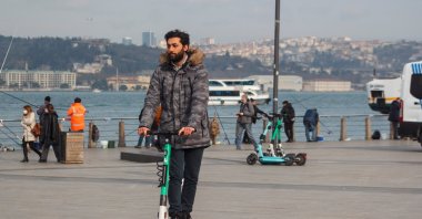 A man is seen riding an electric scooter, Üsküdar, Istanbul, Türkiye, Jan. 2022. (Shutterstock Photo)