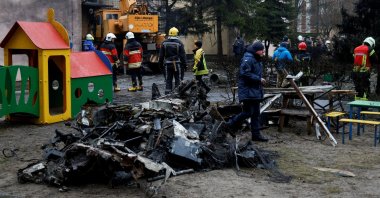 Emergency personnel work at the site of a helicopter crash in the town of Brovary, outside Kyiv, Ukraine, Jan. 18, 2023. (Reuters Photo)