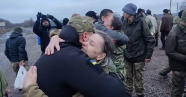 A woman embraces a Ukrainian prisoner of war after a swap, amid Russia's attack on Ukraine, in an unknown location, Ukraine, Dec. 31, 2022. (Reuters Photo)