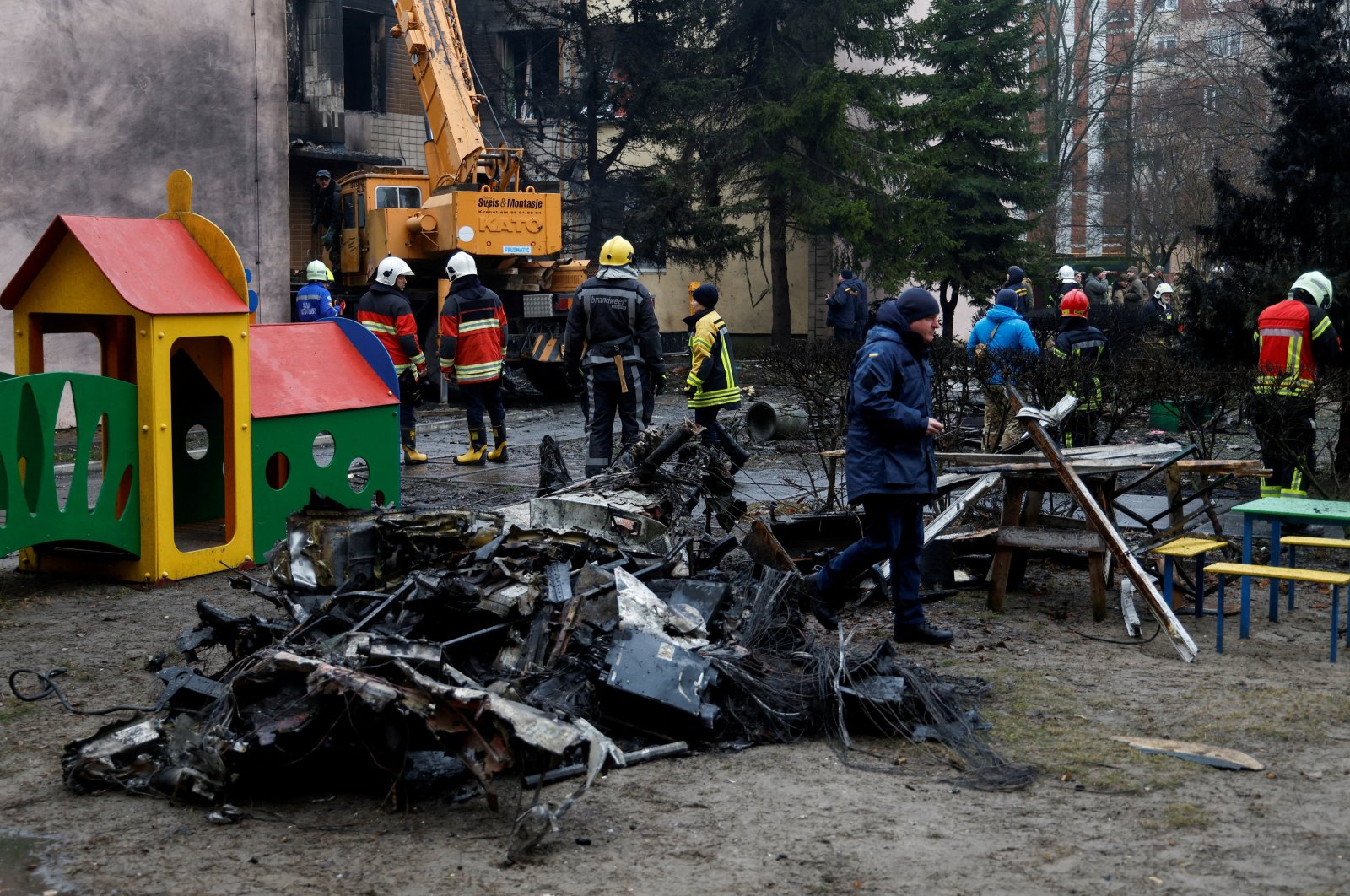Emergency personnel work at the site of a helicopter crash in the town of Brovary, outside Kyiv, Ukraine, Jan. 18, 2023. (Reuters Photo)