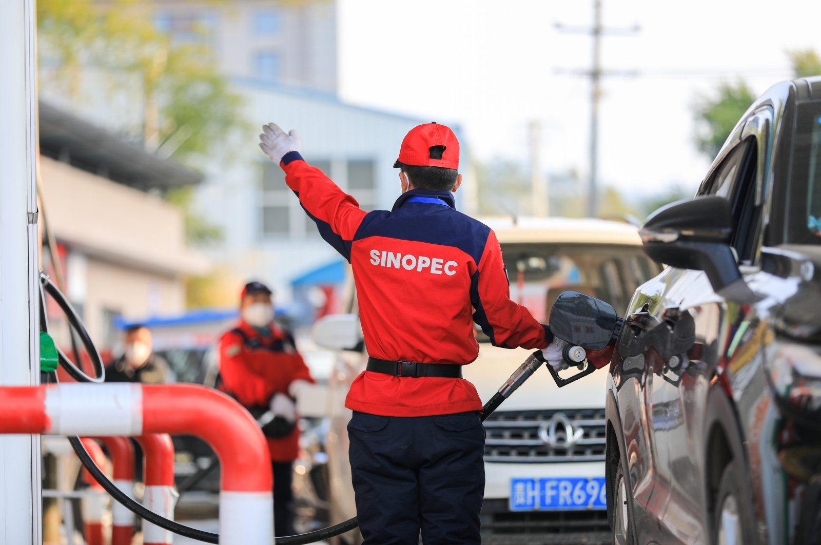 A staff member refuels a vehicle at a gas station in Congjiang County, Guizhou Province, China, Jan. 3, 2023. (EPA Photo)
