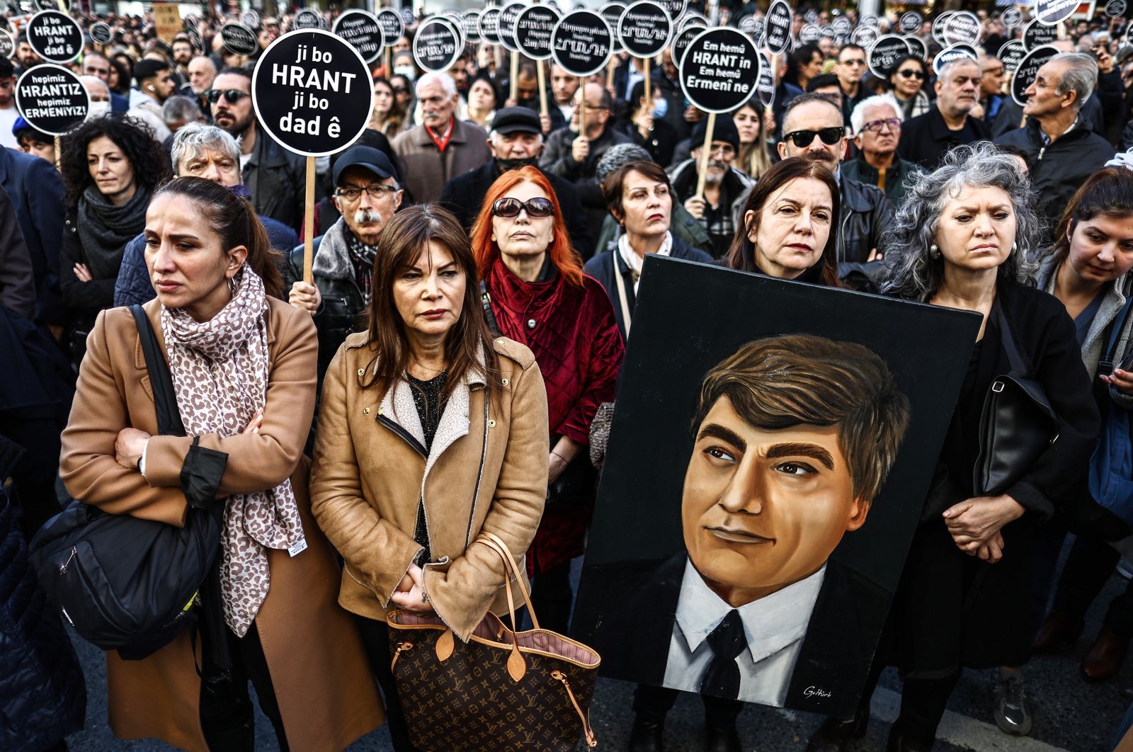 People attend a rally to mark the 16th anniversary of Turkish-Armenian journalist Hrant Dink&#039;s death, in front of the Agos newspaper office in Istanbul, Jan. 19, 2023. (EPA Photo)