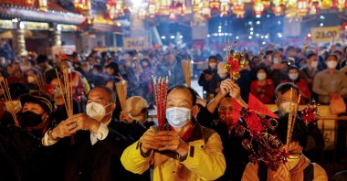 Worshippers wearing face masks make their first offerings inside the Wong Tai Sin Temple, a moment before the Lunar New Year, in Hong Kong, China, Jan. 21, 2023. (Reuters Photo)
